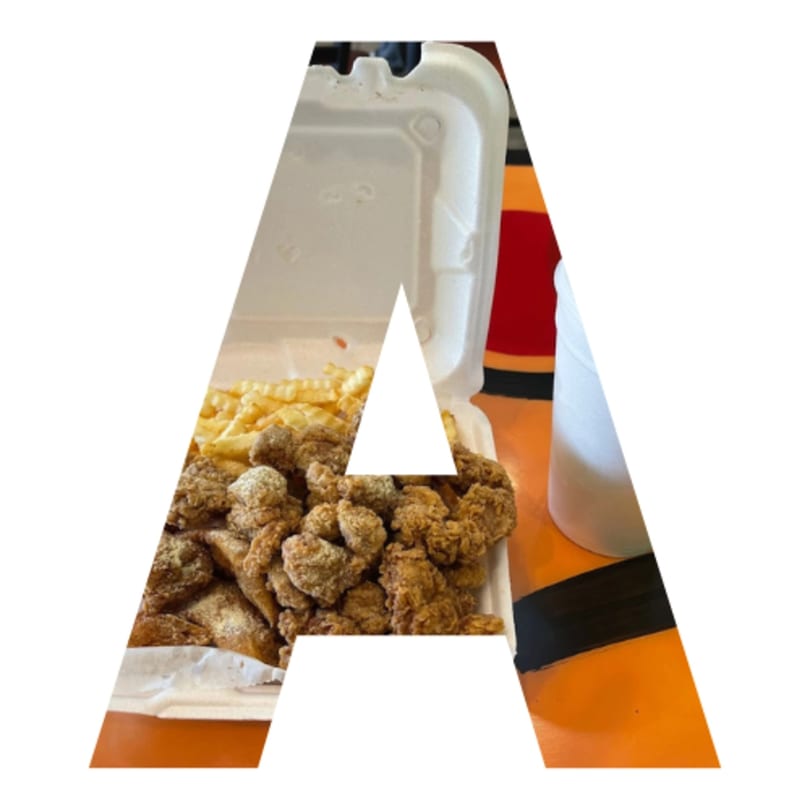 A takeout container filled with golden-brown fried chicken and crinkle-cut fries on an orange table.