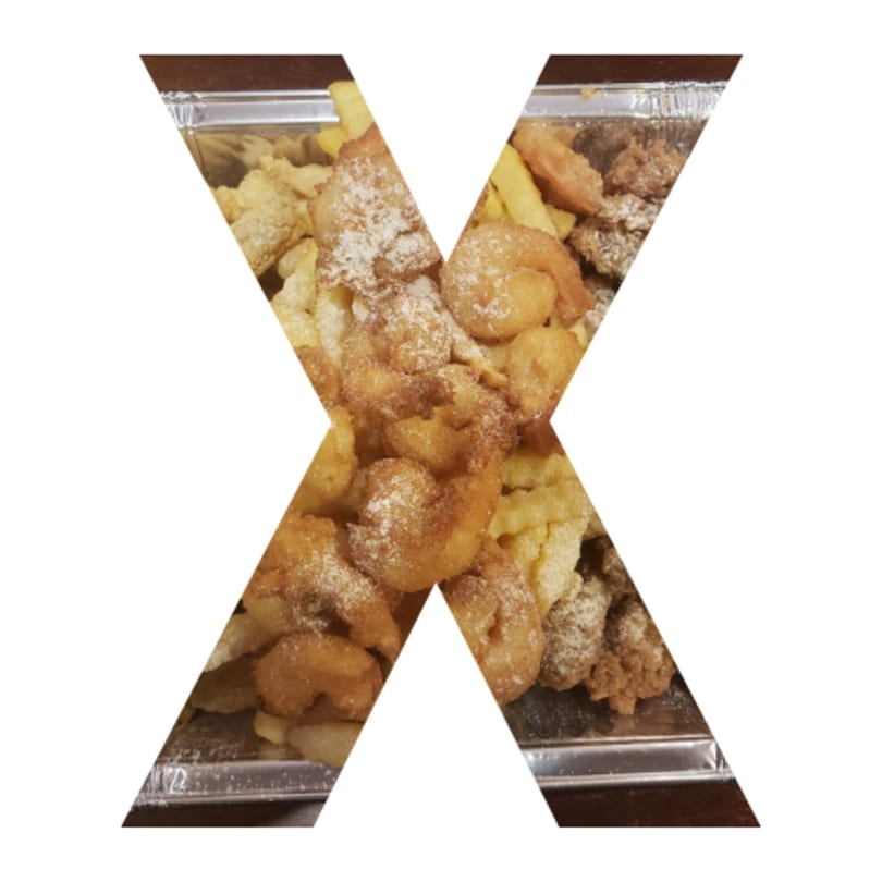 A foil container filled with fried shrimp, chicken, and french fries, dusted with seasoning.